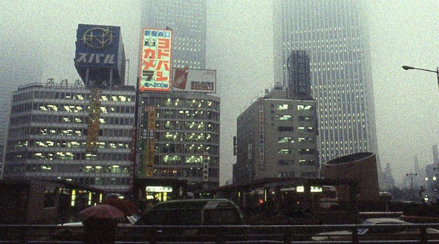 Street view of polluted Tokyo during the 80s, with foggy pollution sky, cars, big tower with glowing ads