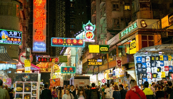 Mong Kok district in Hong Kong, crowded, chaotic and with glowing chinese neons, to showcase the cyberpunk side of the district